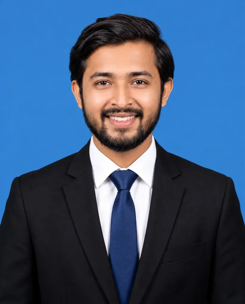 Smiling Bearded Man in a Black Suit and Blue Tie on a Blue Background